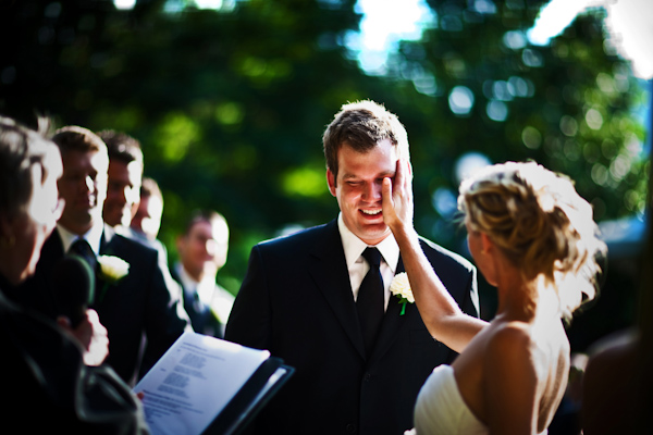 wedding photo by Kevin Weinstein Photography - funny ceremony moment - laughing bride and groom